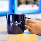 Go Ags! mug in use at a desk